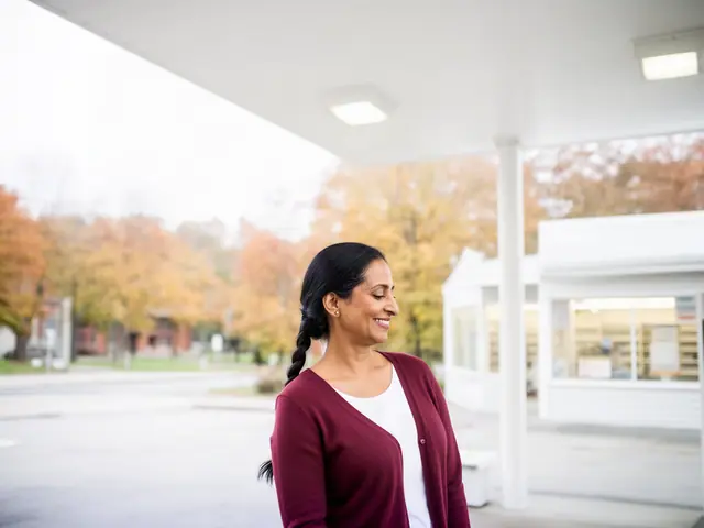 A gas station owner under a white canopy.